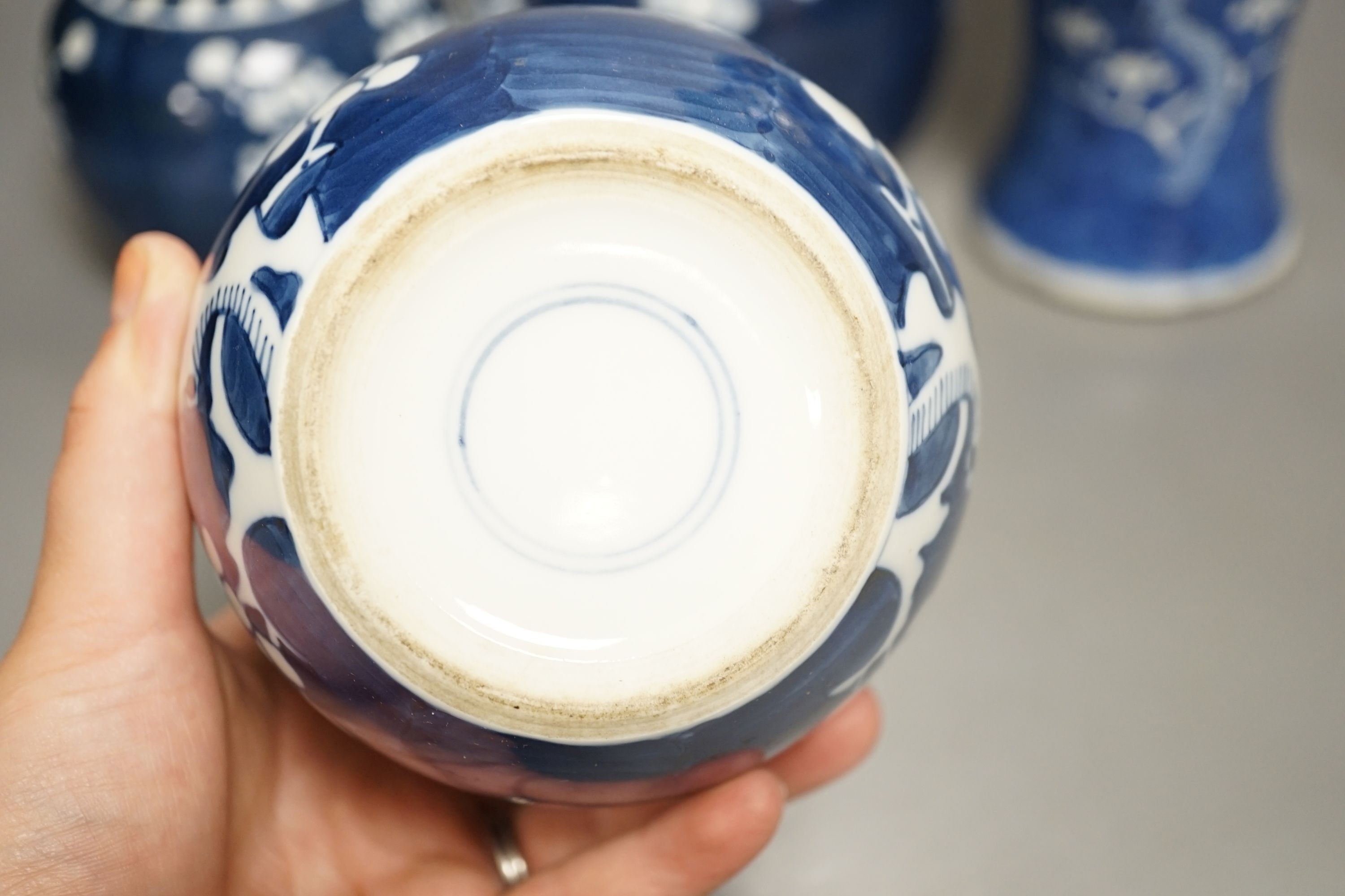 A Chinese blue and white prunus vase together with three similar jars. Vase height 30cm